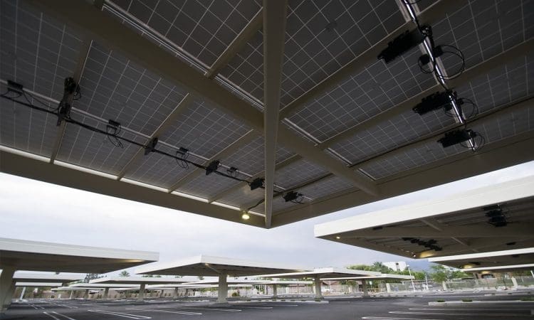 Solar panel canopies installed over an empty parking lot, providing shade and renewable energy.