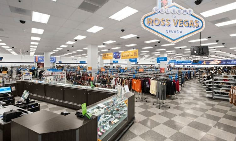 Wide view of a Ross Dress for Less store interior with clothing racks, checkout counters, and a “Welcome to Ross Vegas Nevada” sign overhead.