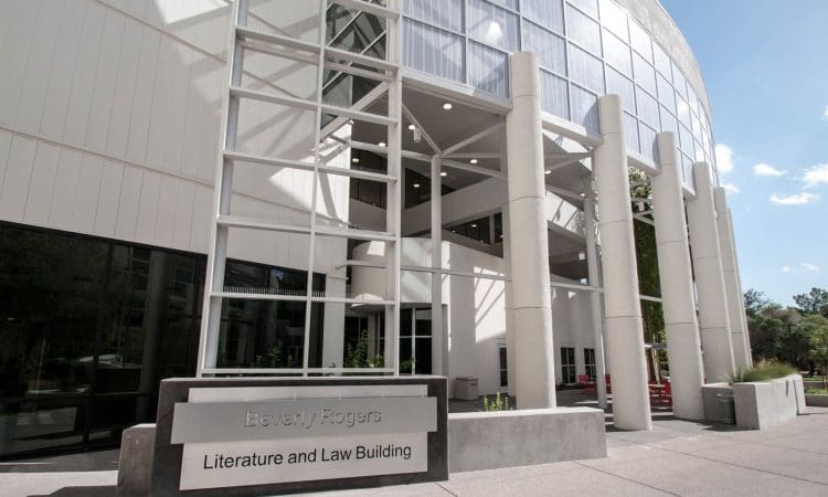 Exterior view of the Beverly Rogers Literature and Law Building with large windows and columns at the entrance.